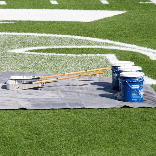 paint buckets on the field with rollers