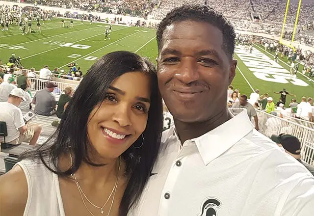 the Muhammads posing at a football game