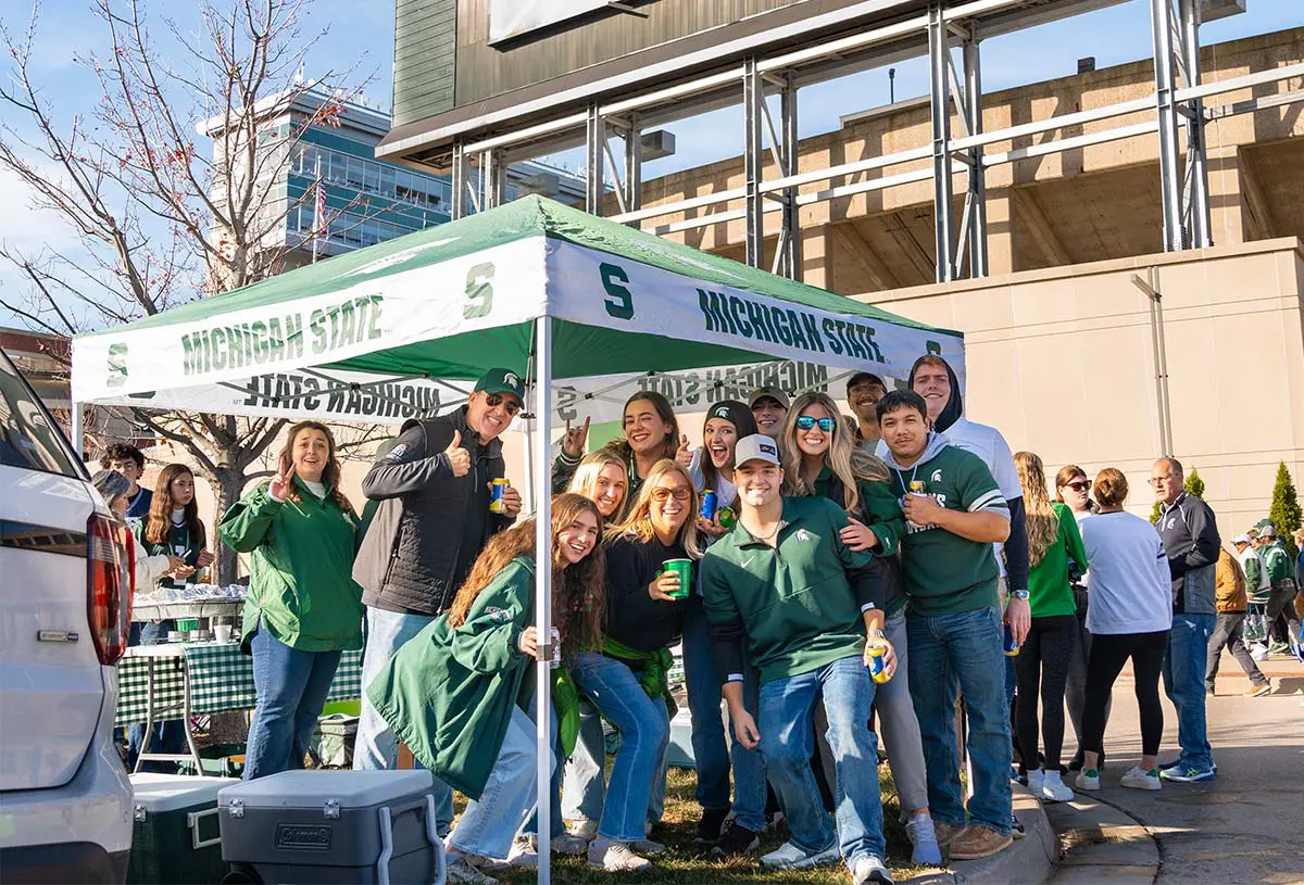 Tailgaters posing under a tent